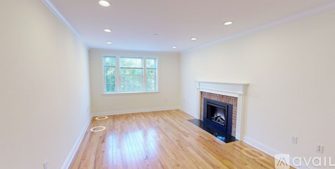 A room with a fireplace and a window.