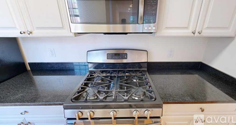 A modern kitchen with a stainless steel stove top.