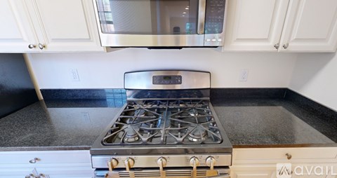 A modern kitchen with a stainless steel stove top.