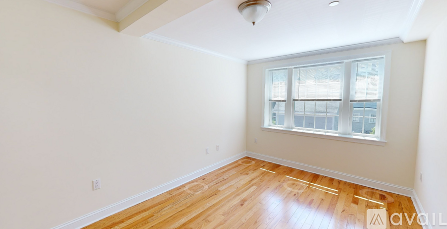 A room with wooden floors and a window.