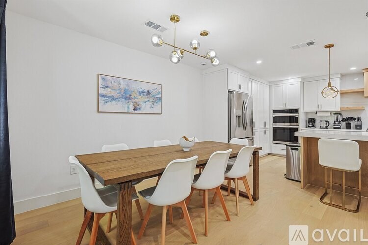A modern kitchen with a dining table and chairs.