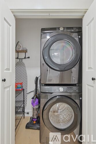 A stack of washers and dryers in a small laundry room.