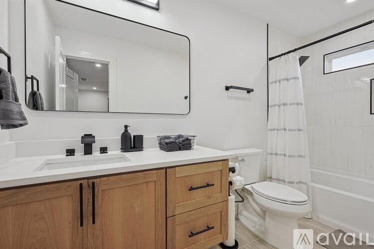 A bathroom with a white sink and a white toilet.
