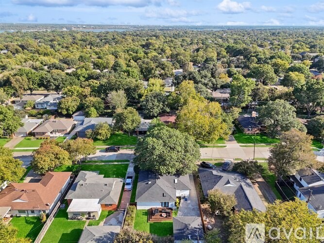 A bird's eye view of a residential neighborhood with houses and trees.
