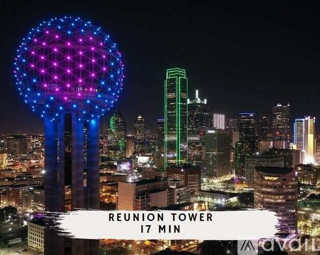 A night view of a city with the Reunion Tower prominently lit up.
