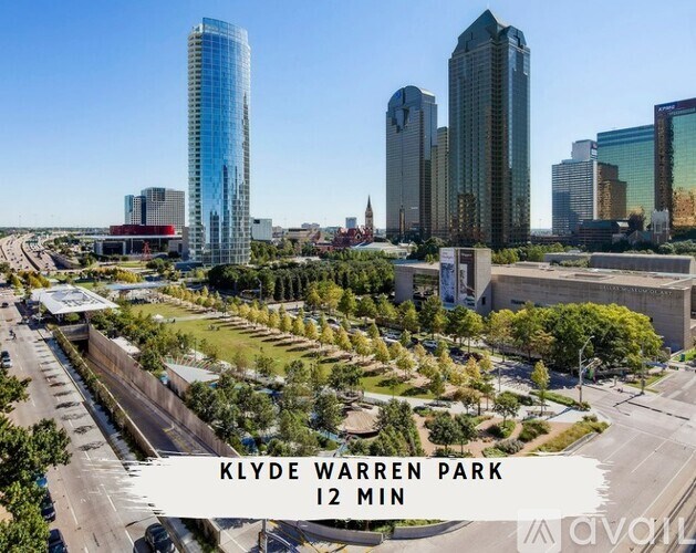 A cityscape with a sign that reads "KLYDE WARREN PARK 12 MIN".