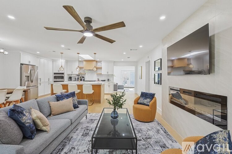 A modern living room with a grey sofa and a black coffee table.