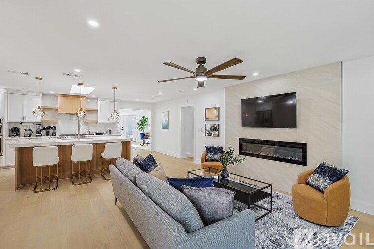 A modern living room with a grey sofa and a wooden coffee table.