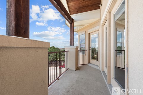 A balcony with a view of the sky and trees.
