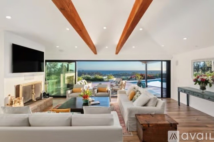 A modern living room with a fireplace and a view of the ocean.