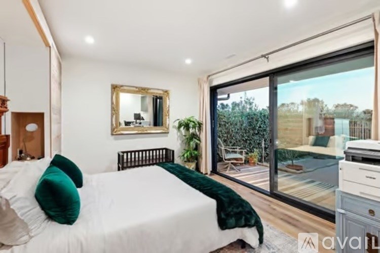 A bedroom with a large bed and a mirror on the wall.