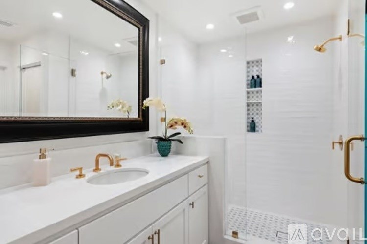 A bathroom with a white sink and a mirror above it.
