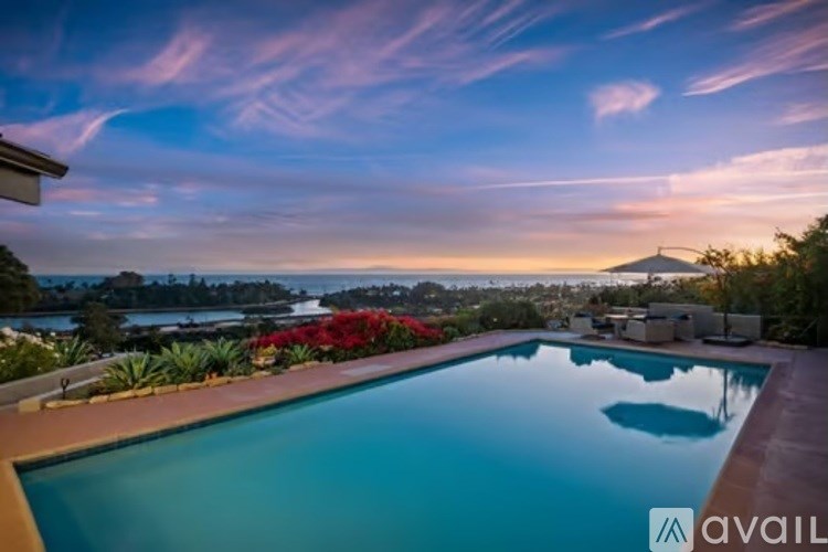 A pool with a view of the mountains at sunset.