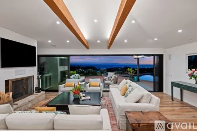A modern living room with a view of the ocean.