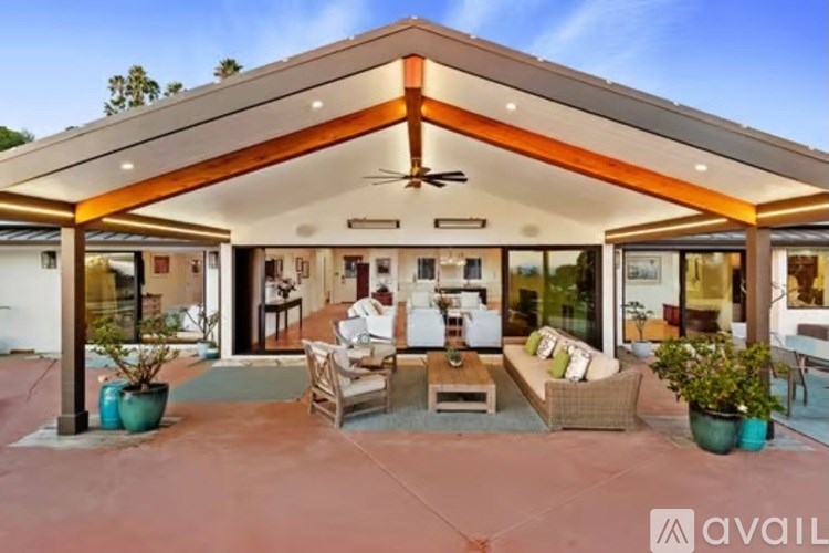 A house with a patio and a person sitting on a chair.