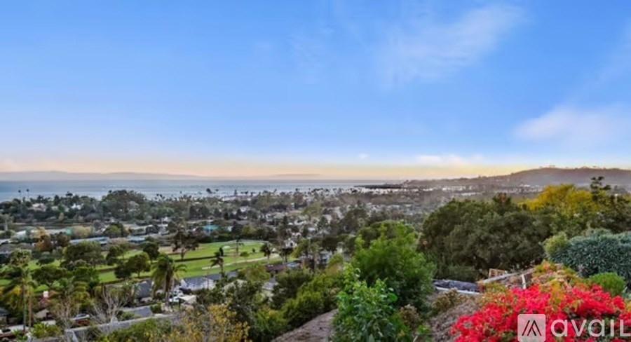 A view of a residential area with houses and greenery.