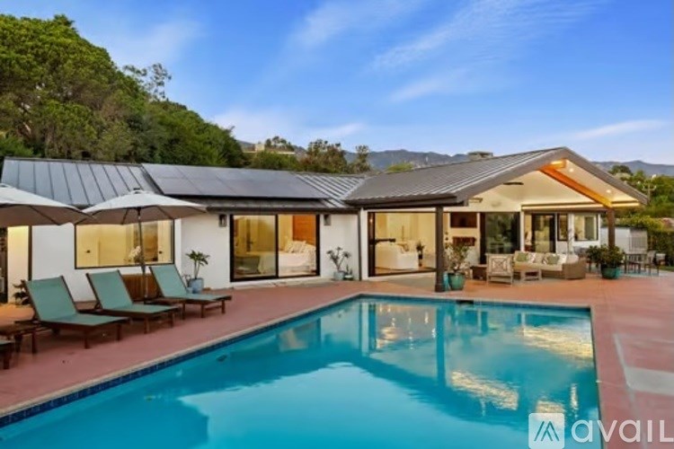 A modern house with a swimming pool in the backyard.