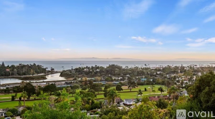 A view of a coastal area with houses and a body of water.