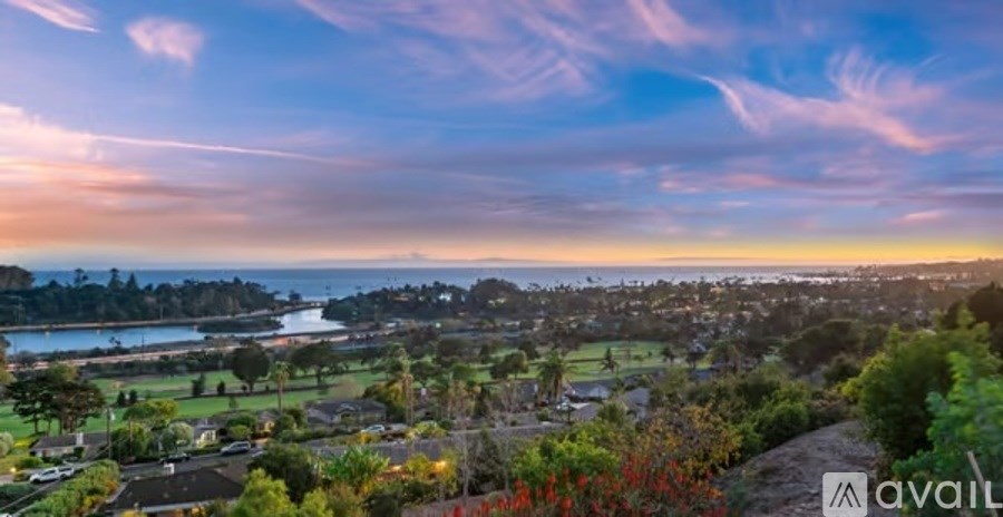A beautiful landscape with a sunset sky and a town in the distance.