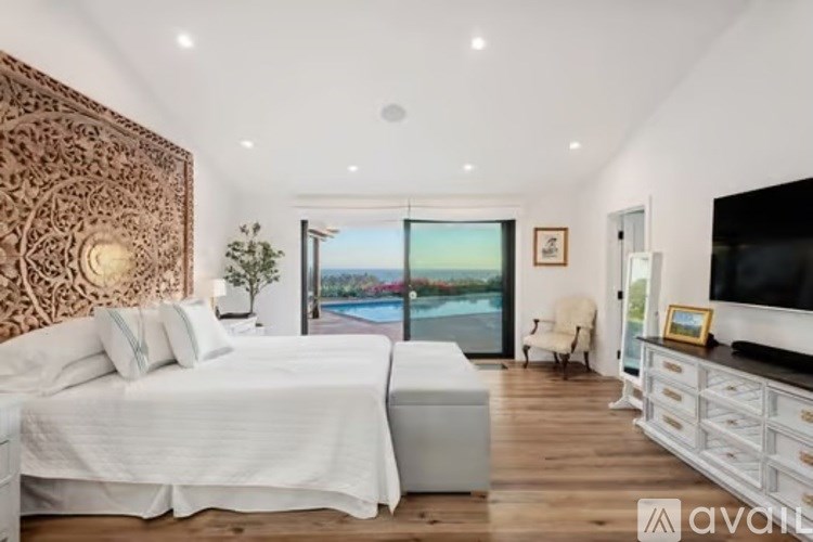 A bedroom with two beds and a television.