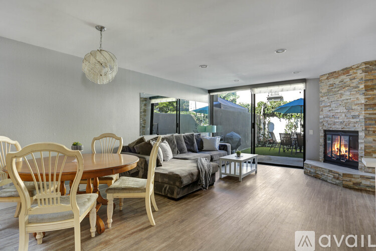 A modern living room with a fireplace and a dining table set up.