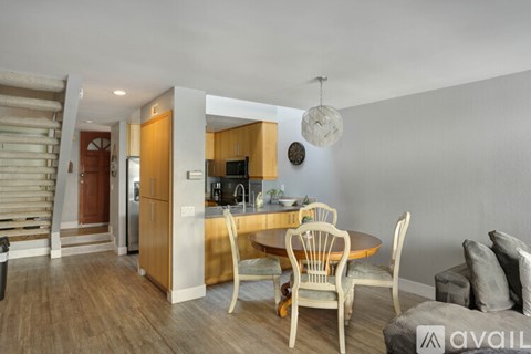 A kitchen with a dining table and chairs is available for rent.