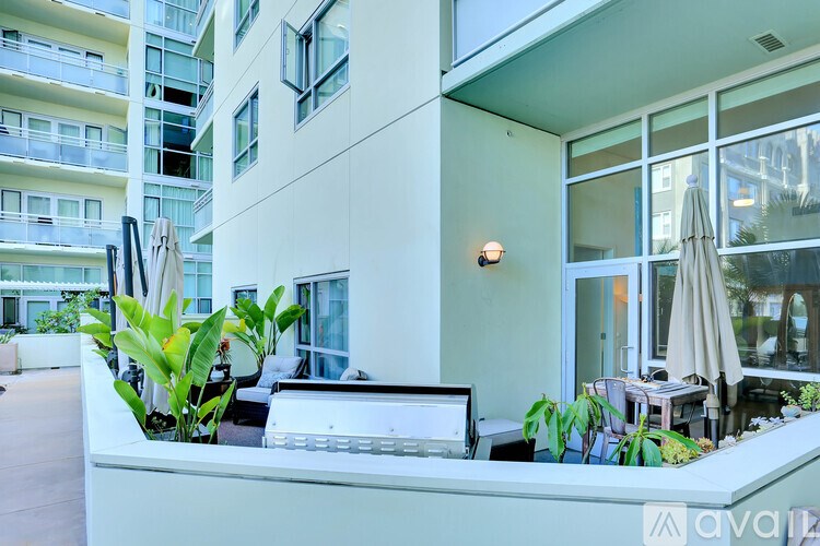A patio area with a table and chairs and umbrellas.