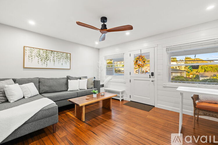 A living room with a grey couch and a wooden coffee table.
