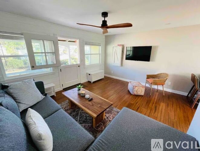 A living room with a grey couch and a wooden coffee table.