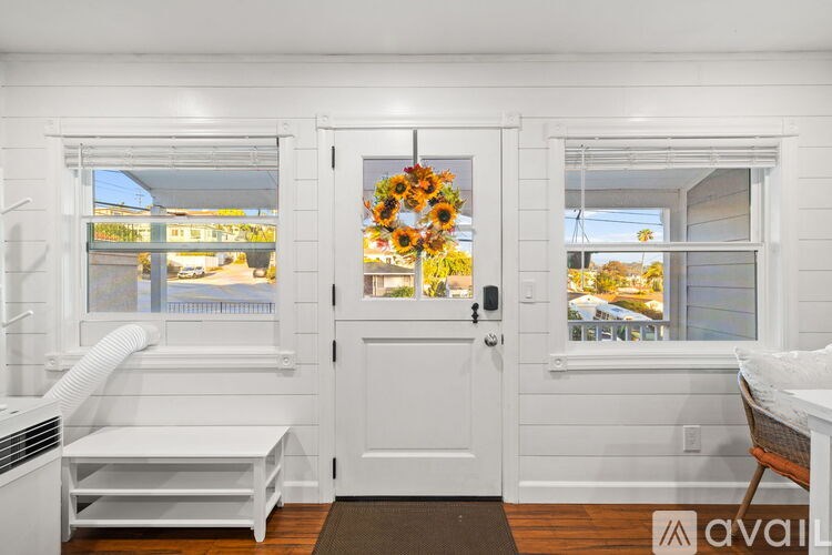 A room with a desk, chair, and window.