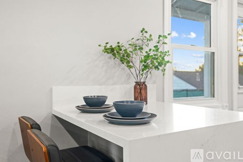 A small table and two chairs are on a porch.