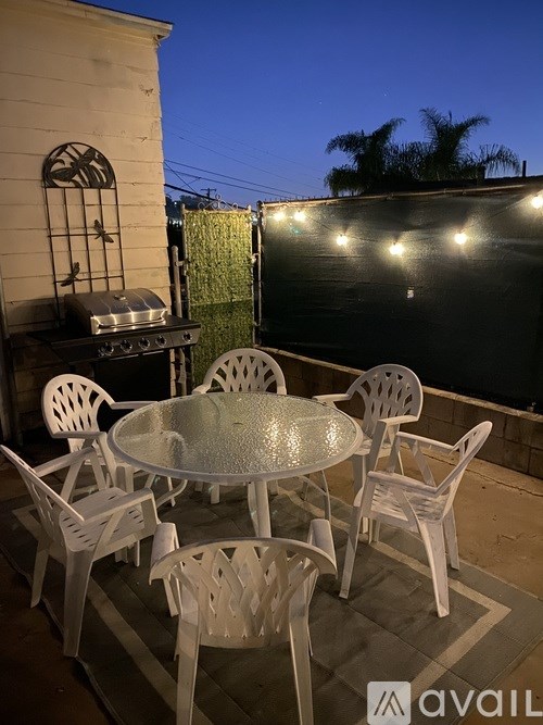 A table with chairs is set up on a patio.