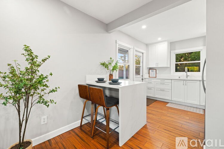 A bedroom with a bed, a ceiling fan, and a window with blinds.