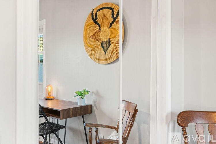 A wooden table with a candle and a plant on it.