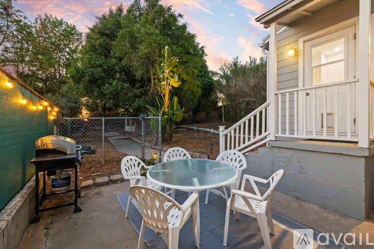 A patio with a table and chairs is set up on a balcony.