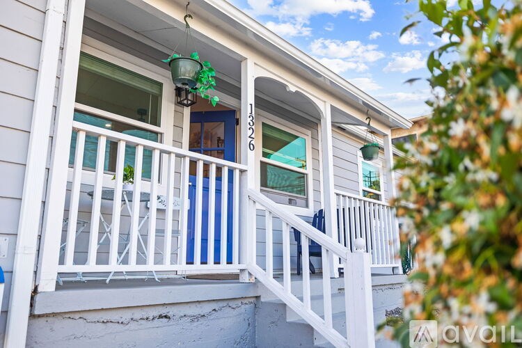 A house with a blue door and white railings.