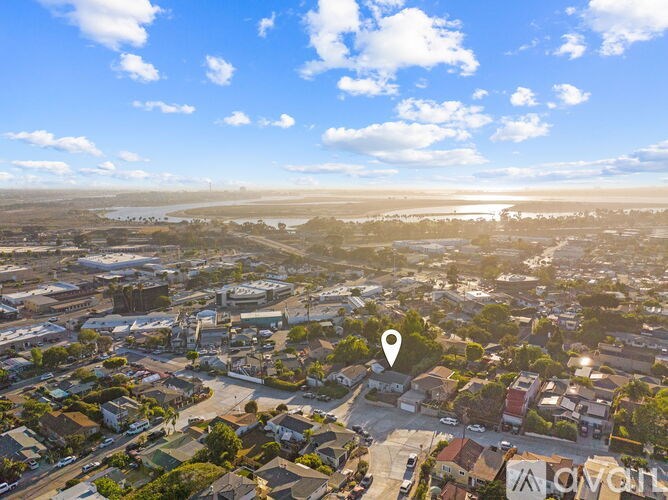 A bird's eye view of a residential area with a clear blue sky.
