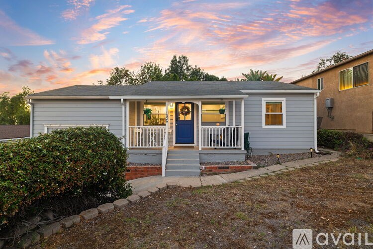A small house with a front porch is available for rent.