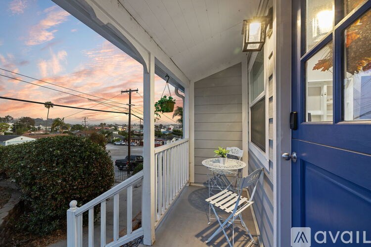A living room with a flat screen TV mounted on the wall.