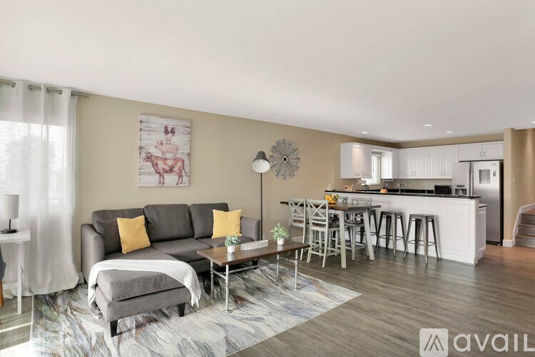 A modern living room with a grey sofa and a coffee table in the center.