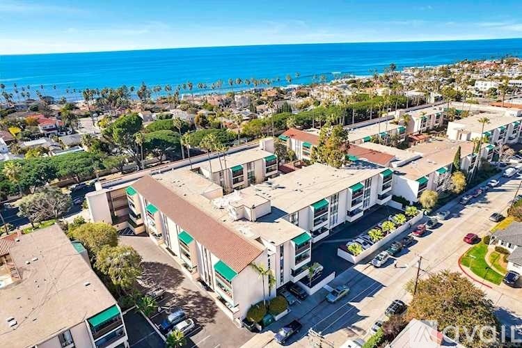 A coastal town with apartment buildings and a view of the ocean.