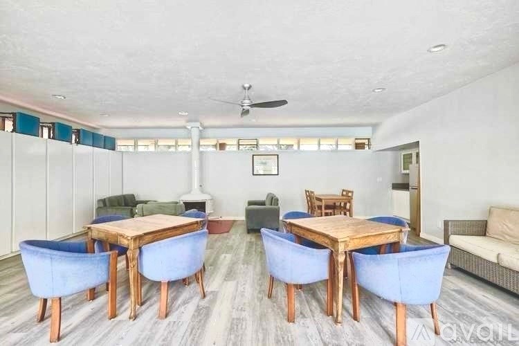A living room with a dining table and chairs.
