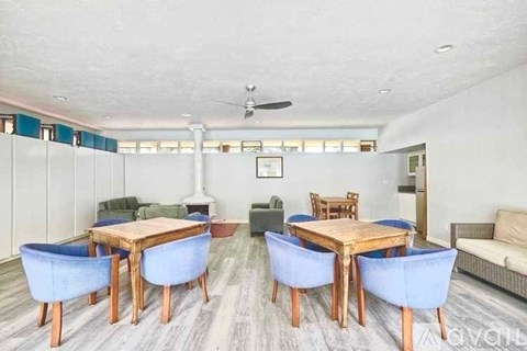 A living room with a dining table and chairs.