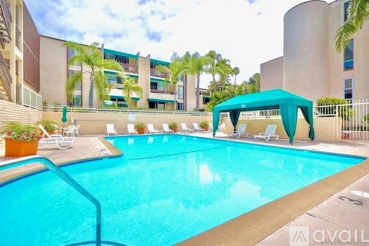 A swimming pool with a blue cover and chairs around it.