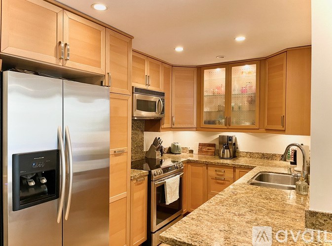 A kitchen with granite countertops and stainless steel appliances.