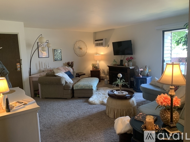 A living room with a couch, chair, and lamp.