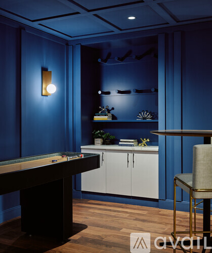 A pool table in a room with blue walls.