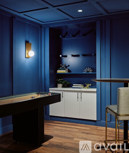 A pool table in a room with blue walls.