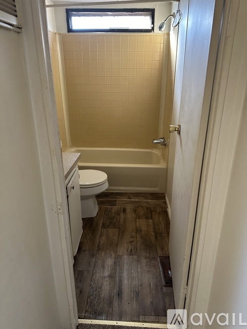 A small bathroom with a toilet and a bathtub.