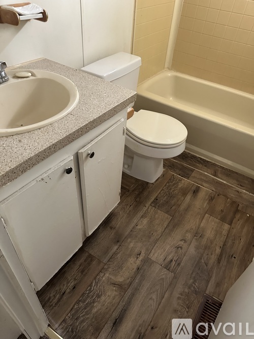 A bathroom with a toilet, sink, and bathtub.